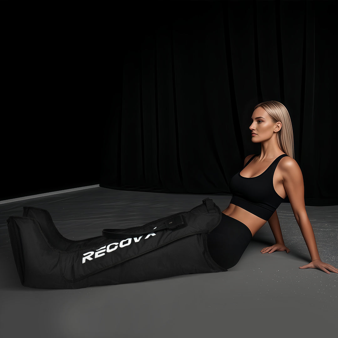 ​A healthy, slender woman uses dynamic air compression massage post-workout to massage her leg muscles, aiding rapid recovery.