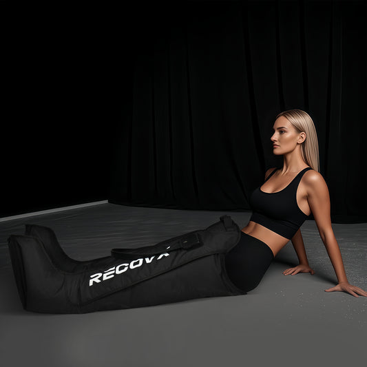 ​A healthy, slender woman uses dynamic air compression massage post-workout to massage her leg muscles, aiding rapid recovery.